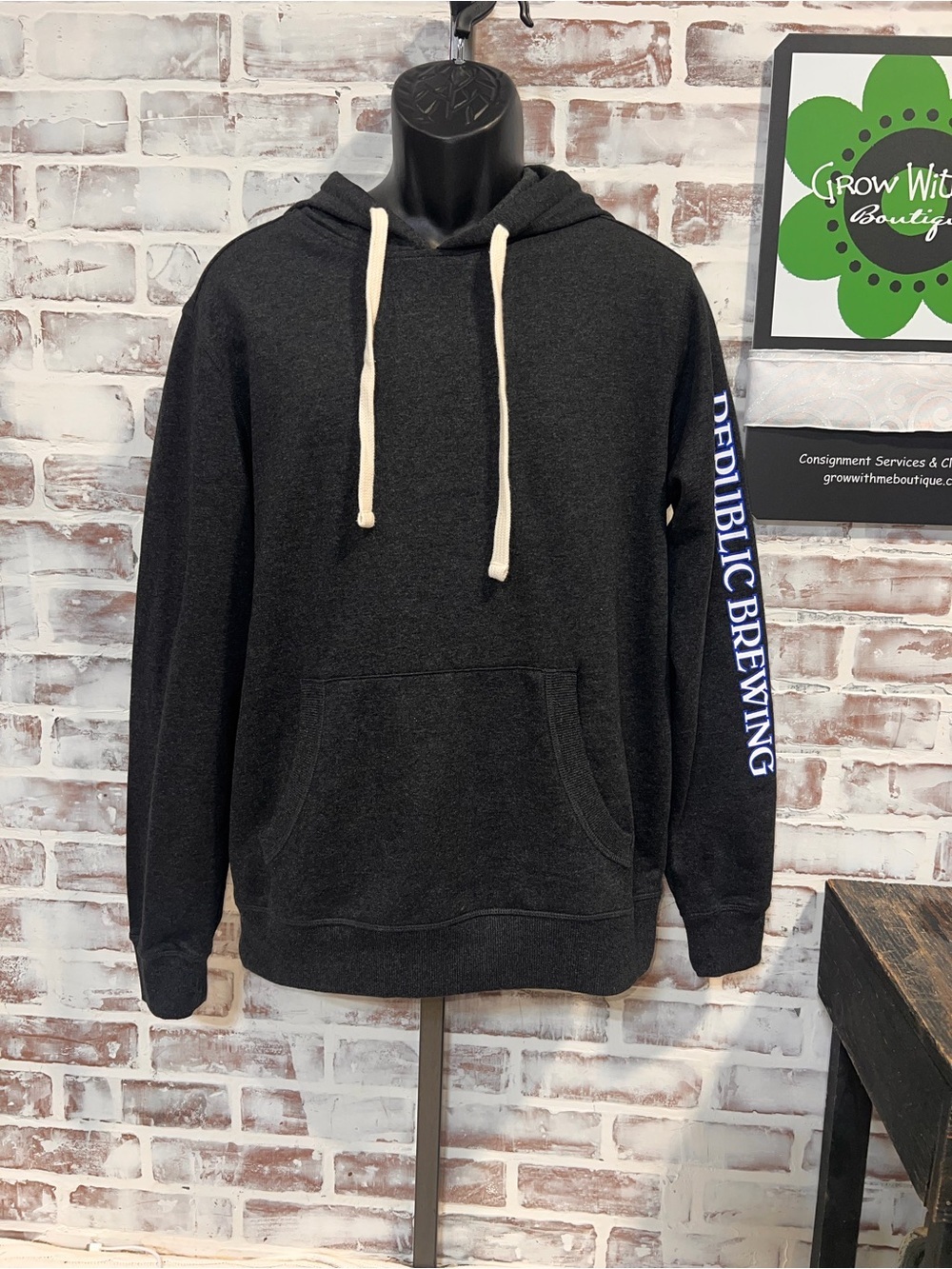 District Black Hoodie with Cream Drawstrings and Blue Sleeve Logo